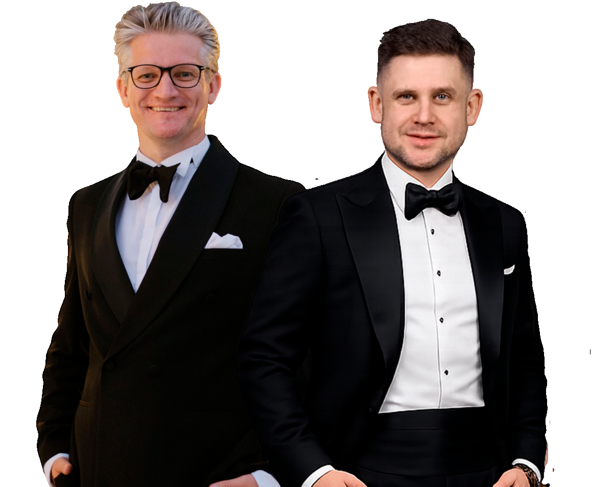 Two men wearing black tuxedos.